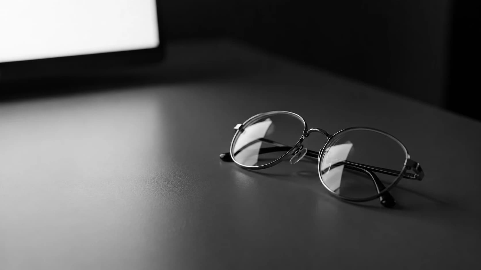 Close view of a screen edge with a soft focus falloff, suggesting strained near vision at a desk